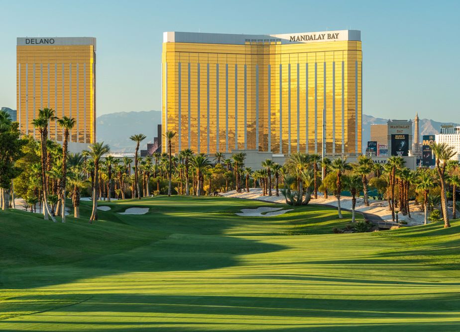 view of the fairway at Bali Hai Golf Club with the golden-colored mandalay bay casino towering over at the backdrop