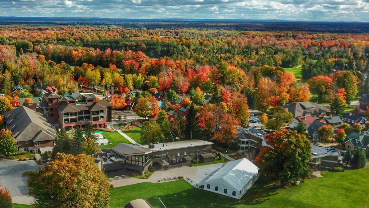 breathtaking aerial view of the crystal mountain golf course lined by fiery autumnal trees 