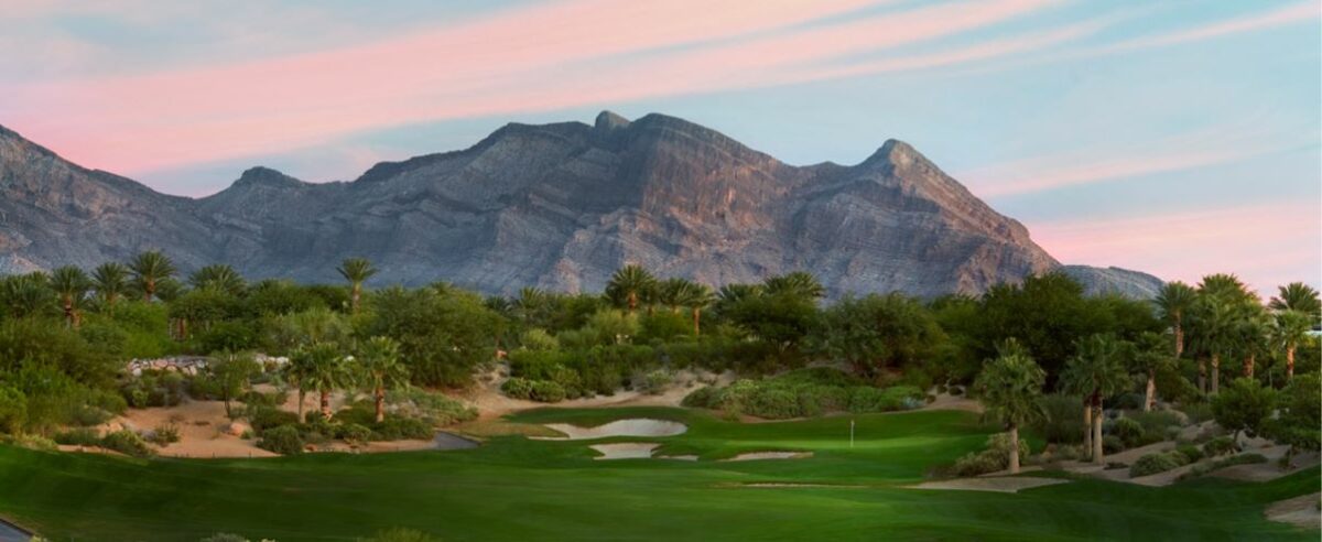 view of the greens at the Red Rock Country Club with the majestic  mountain as the backdrop
