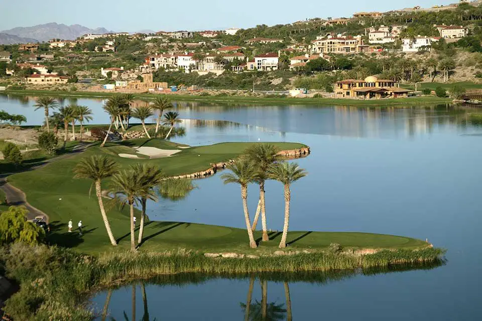 aerial view of a hole Reflection Bay Golf Club with the lake surround and the hills in the background 