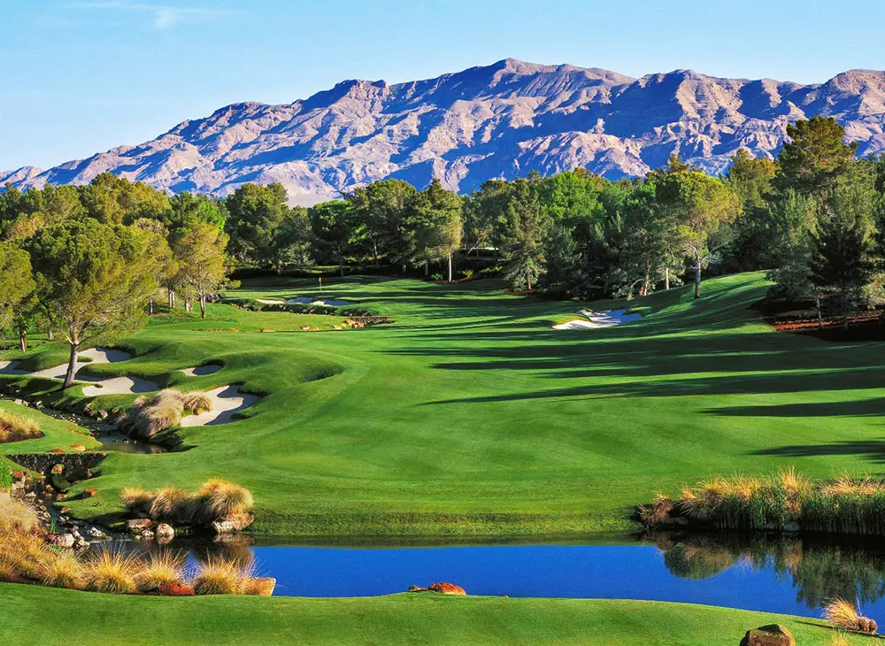 view of the 9th hole a the Shadow Creek Golf Course with the mountains forming the backdrop