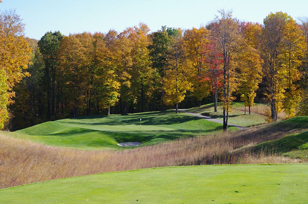 view of hole number 5 at True North Golf Club with the beautiful autumnal trees in the background
